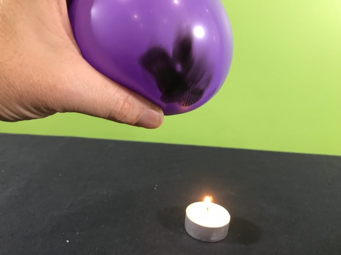 Balloon survives the flame science experiment - soot from the candle flame on the balloon