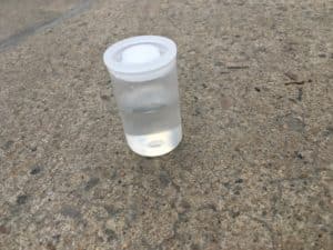 Bicarb film canister rocket science experiment - film canister with vinegar and bicarbonate soda ready to react