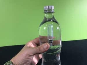 Cartesian diver science experiment - squeezing water bottle causing the pipette to sink