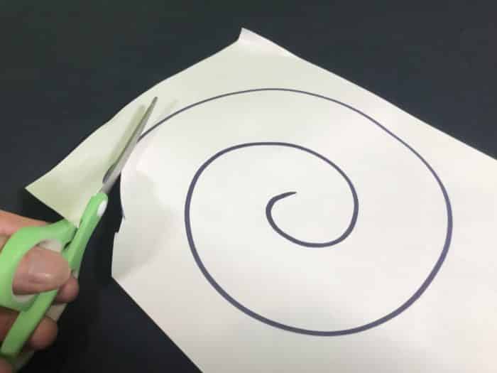 Convection spiral science experiment - cutting out the spiral of paper