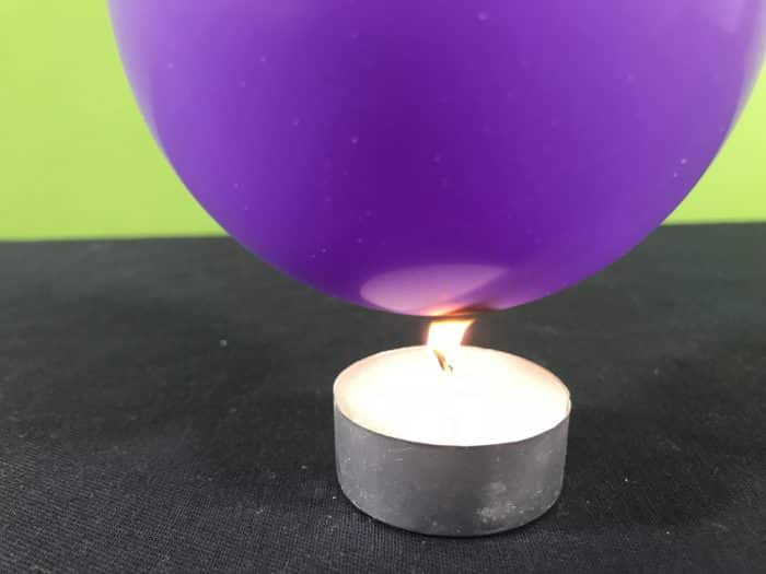 Balloon survives the flame science experiment - balloon touching the candle flame