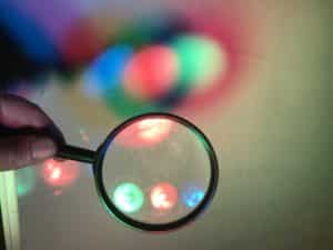 Create coloured shadows science experiment - magnifying focusing red green and blue light
