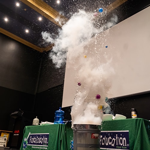 Balls and water flying out of a metal bin