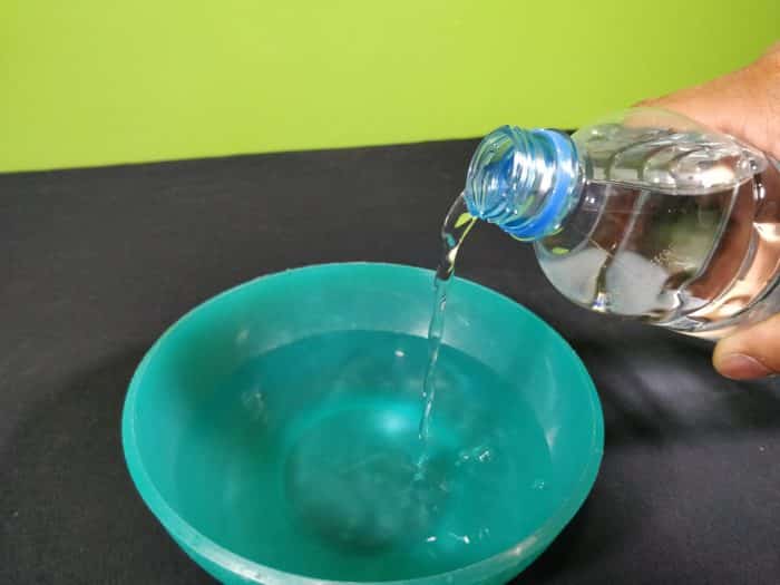 Pouring water in a green bowl