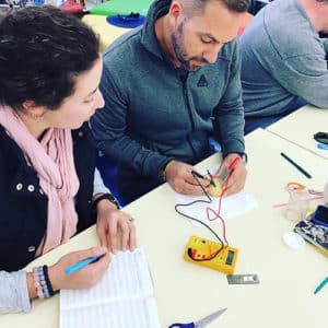 lady and a man working out an electric circuit