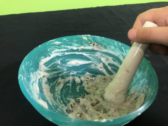 Recycle paper science experiment - using mortar and pestle on newspaper mix