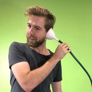 A person holding a funnel and hose to his ear