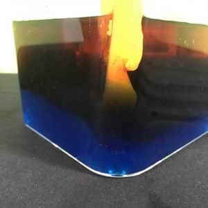 Different layers of coloured water in a plastic tub
