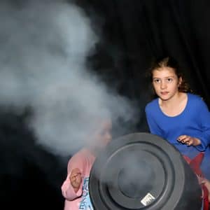 Kids shooting vortex fog rings out of a bin