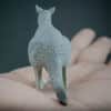 Eastern grey kangaroo replica placed in the palm of a hand. Back view
