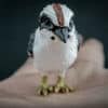 Kookaburra replica on the palm of hand. Front view