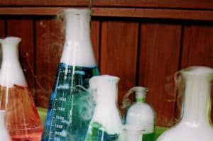 Smoke coming out of beakers which have coloured water and dry ice in them