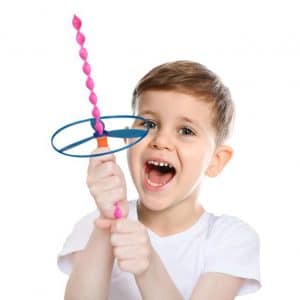 A child holding a Helicopter spiral top with a smile