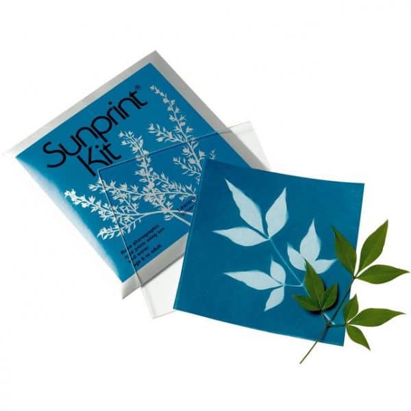 Sunprint Kit on a white background. There is a leaflet next to a cunprint paper that now has a white outline of the leaftlet, with the rest of the paper now blue due to sunlight