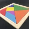 close photo of a Wooden tangram puzzle set in a square