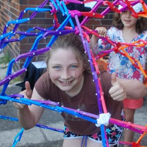 Girl inside a huge hoberman sphere during a kids science party