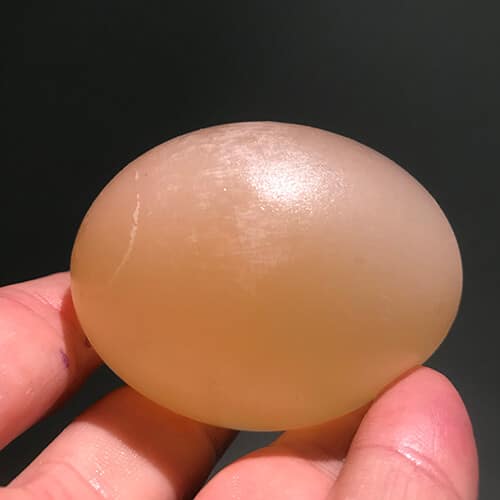 Naked egg without a shell getting held