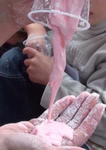 pouring pink slime into hand