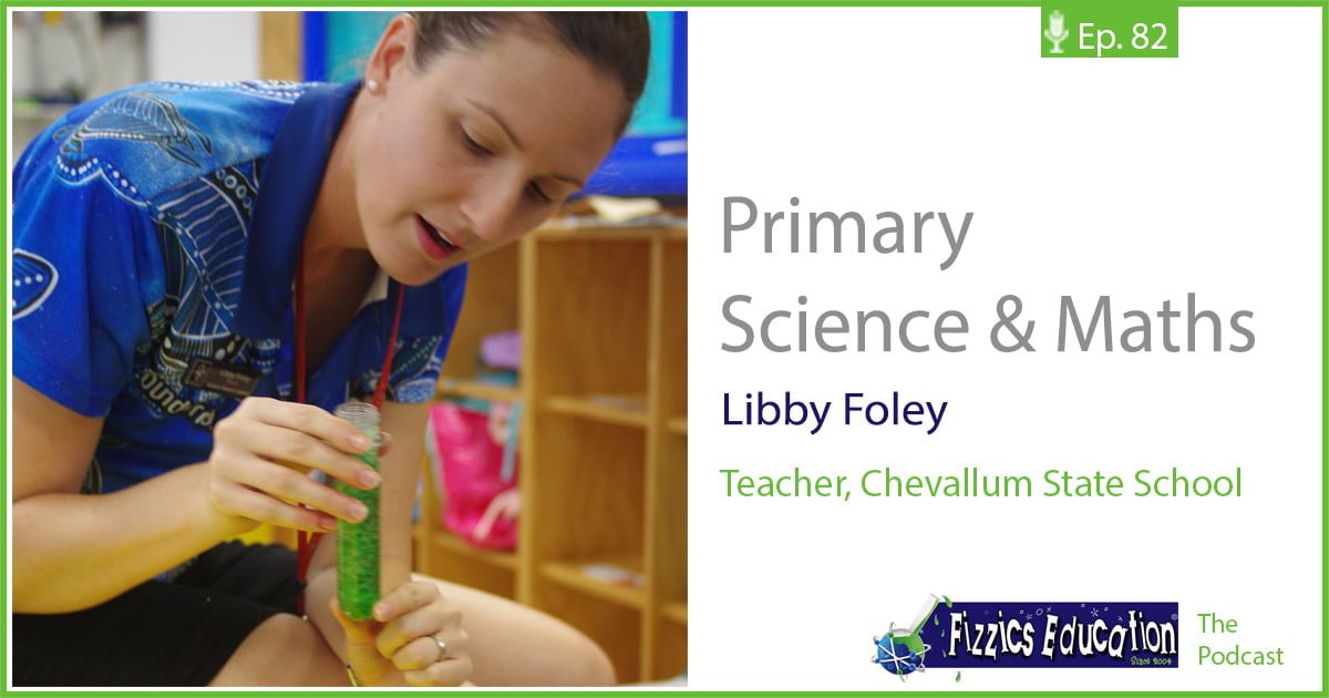 Libby Foley holding up a test tube with green liquid in it