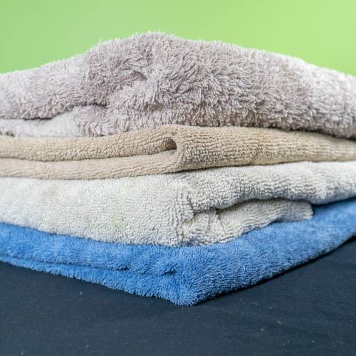 Four towels of different colours stacked on top of each other