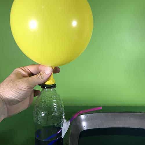 Holding a balloon on the bottle fountain