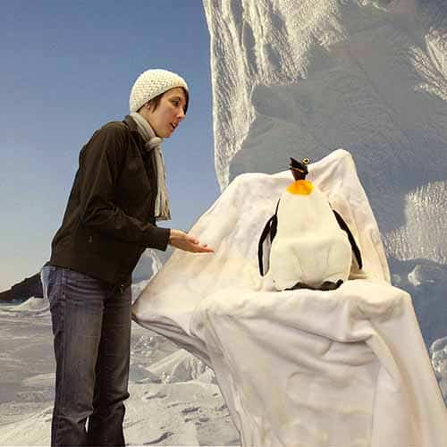 A woman talking to a penguin