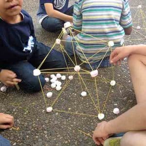 Spaghetti and marshmallow tower on the ground in the shape of a cube
