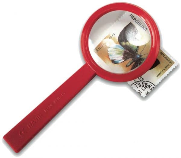 Red magnifying glass looking at postage stamp