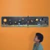 A child looking at the Create your own solar system wallchart