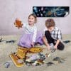 Two kids building the Jahgo submarine floor puzzle on carpet
