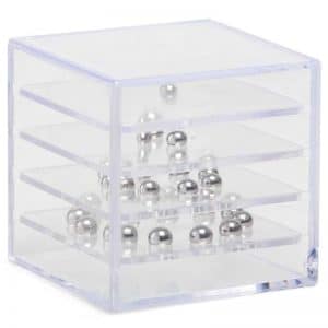 A clear plastic box with 4 levels inside, whereby ball bearings have settled in a pyramid shape
