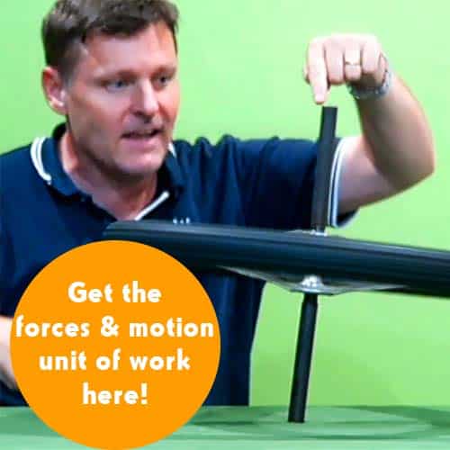 A man pointing at a bicycle wheel spinning horizontally on a desk (balancing by itself)