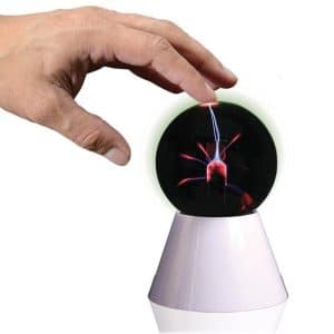 A hand touching a plasma globe. A spark is leaving the tesla coil and moving to the hand
