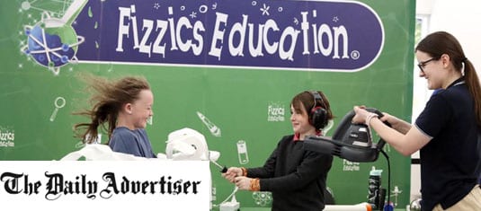 A woman holding a leafblower whilst two kids spray toliet paper at each other. The Fizzics Education banner is in the background