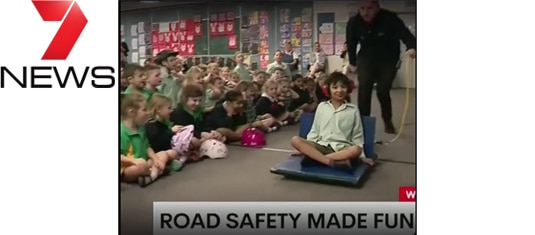 A child on a leafblower hovercraft in front of laughing children